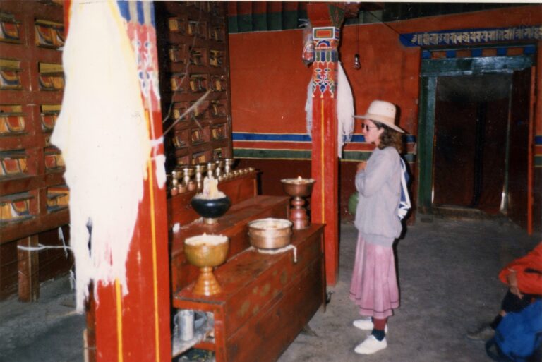 Photo: author stands before altar and sutra manuscripts inside Potala Palace